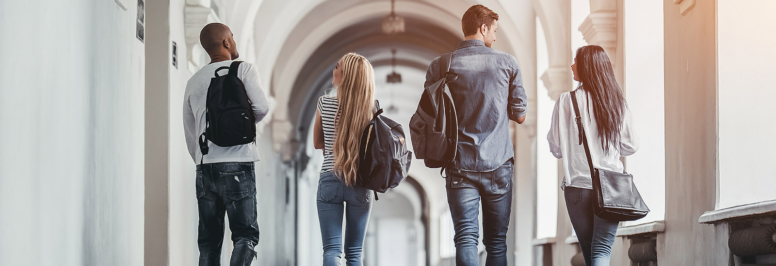 Group of college students walking on campus