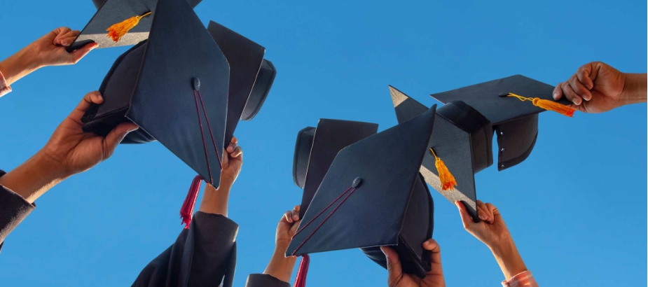 Graduation caps being lifted into the air