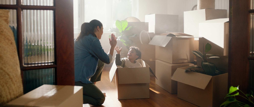 Mother and child surrounded by packing boxes