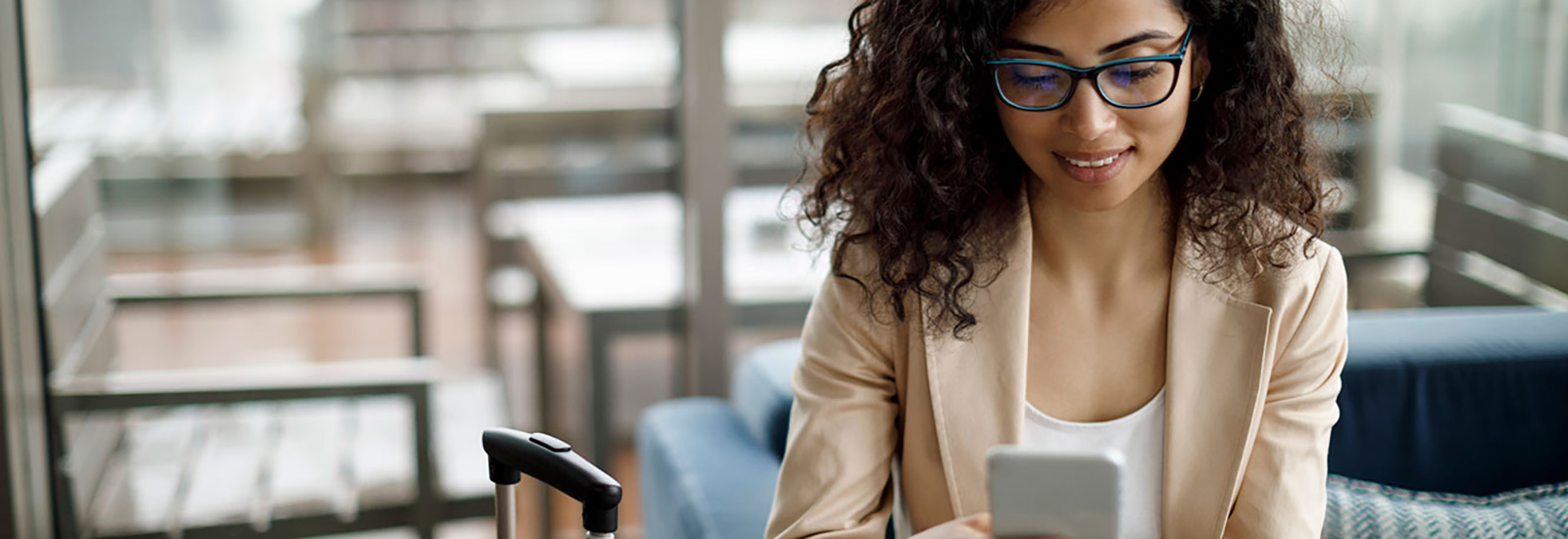 Young woman using phone in office