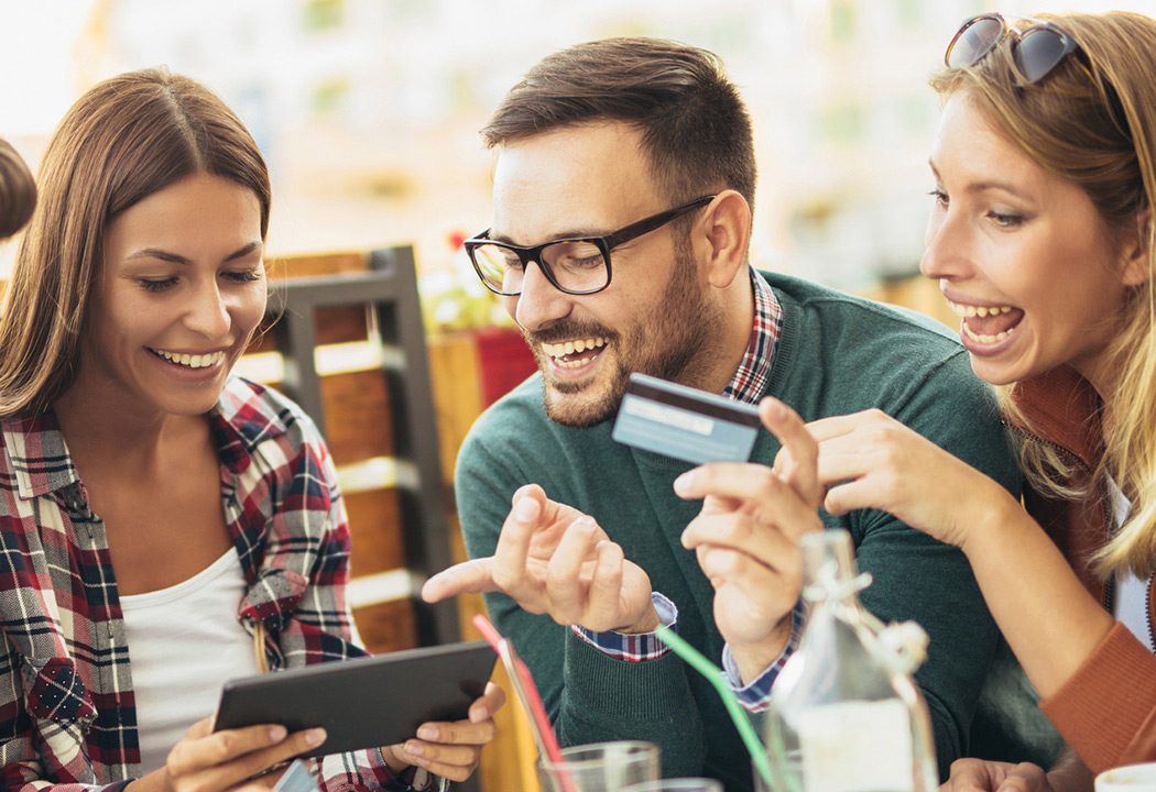 Friends paying for meal with their credit card.