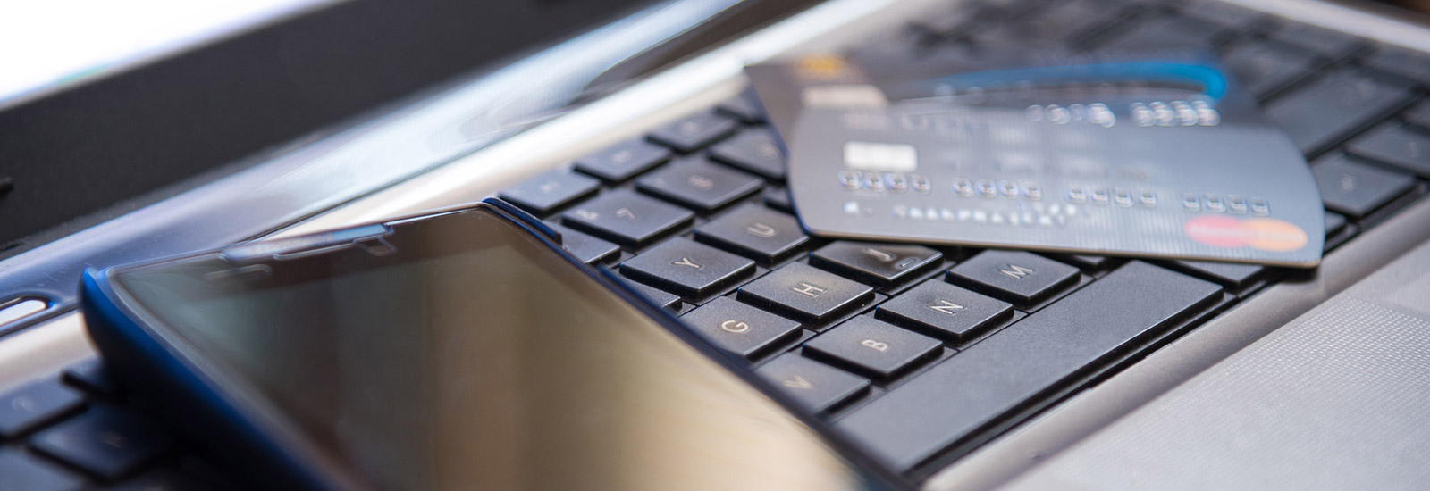 Phone and credit cards laying on keyboard