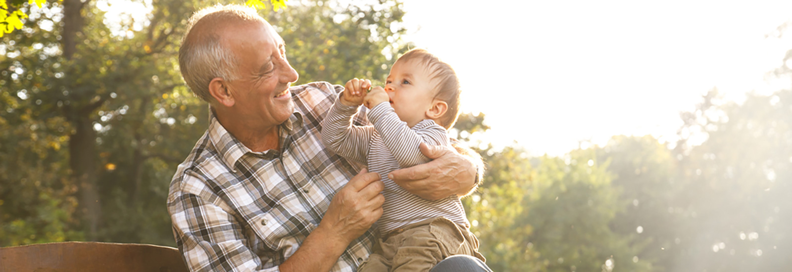 Grandfather and grandson outside sitting on bench