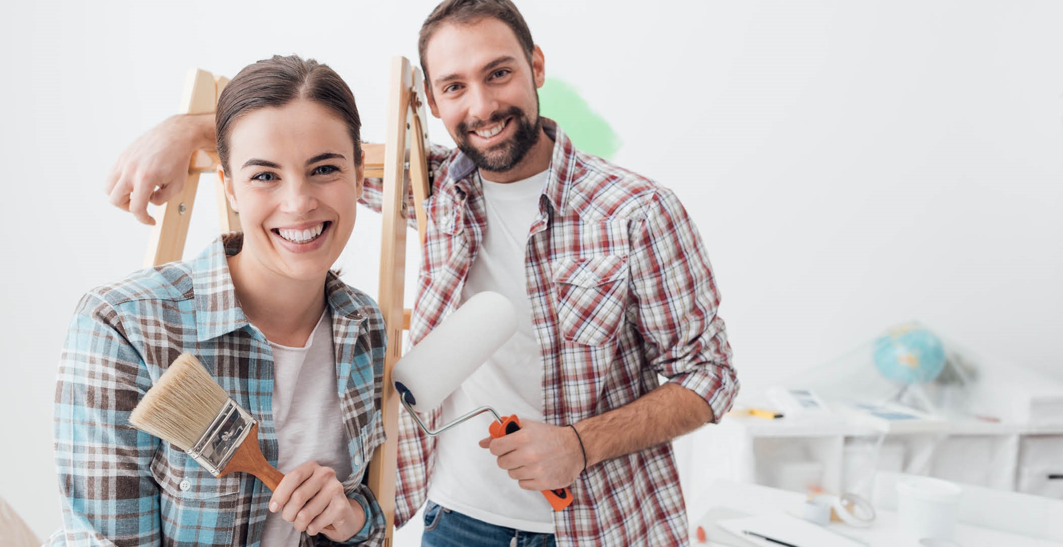 Couple painting inside of room