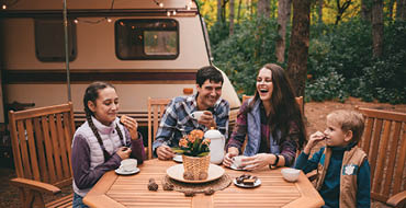Family camping and eating outdoors