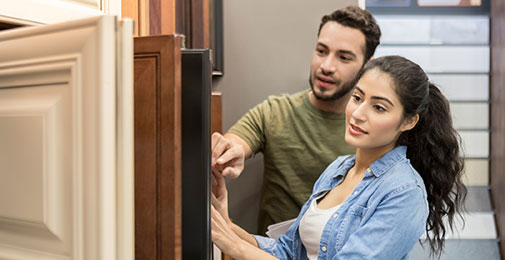 Young couple going through cabinet samples
