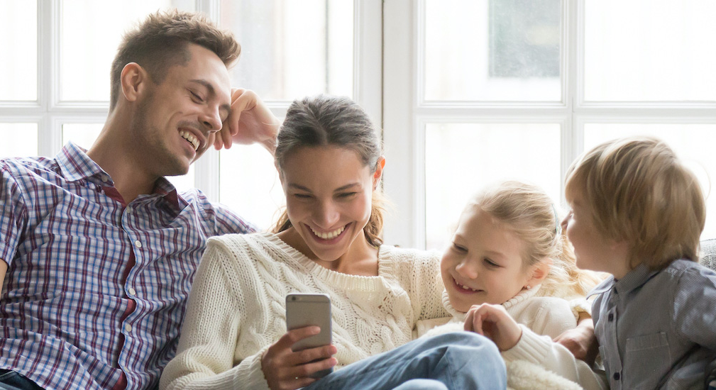 Family looking at mobile phone