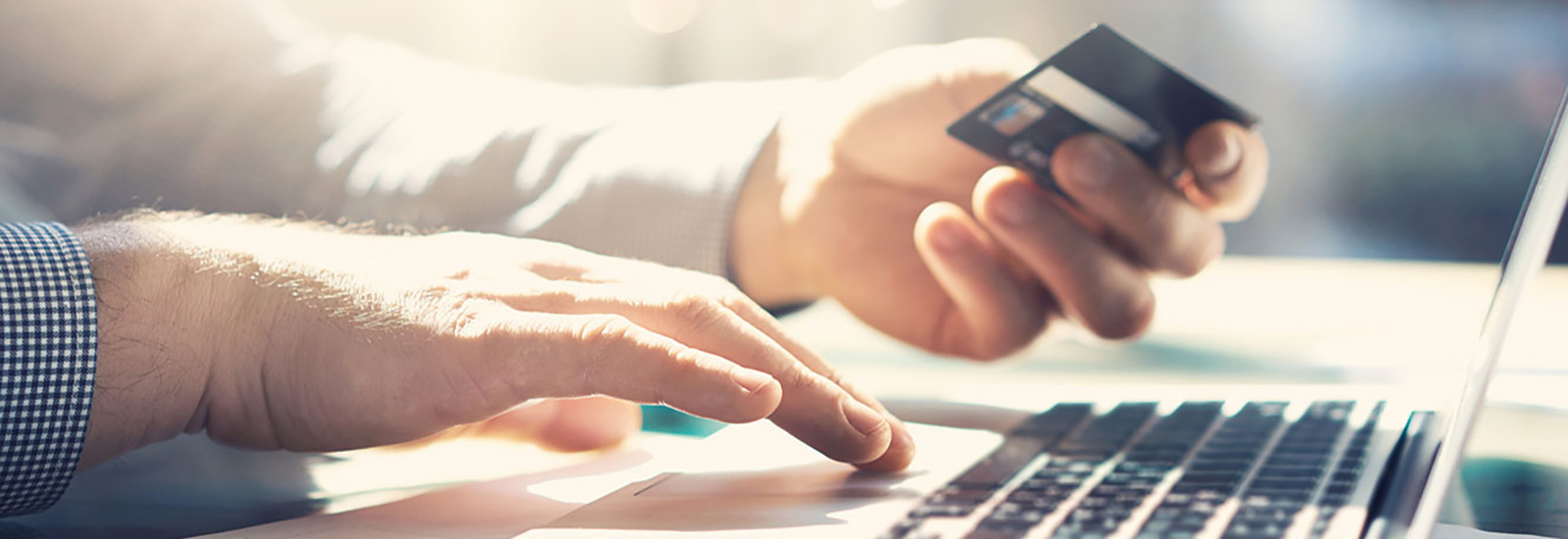 Man using card while online shopping